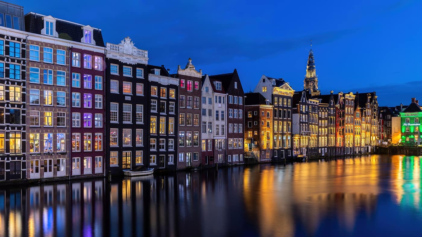 Canal houses reflected in the water in Amsterdam