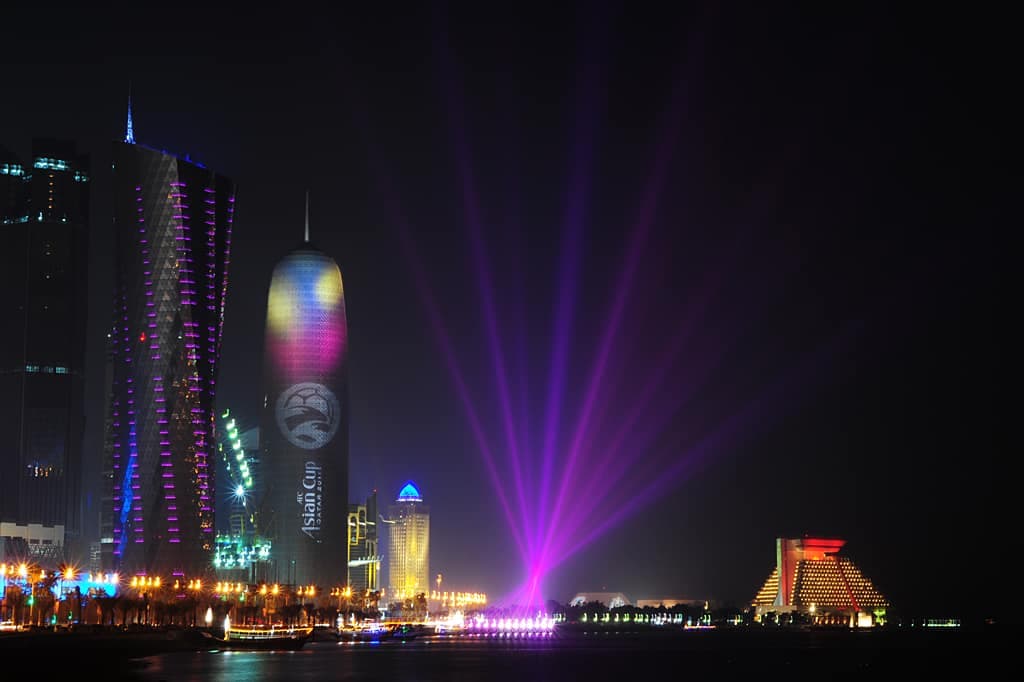 West Bay towers lit at night along the Doha Corniche