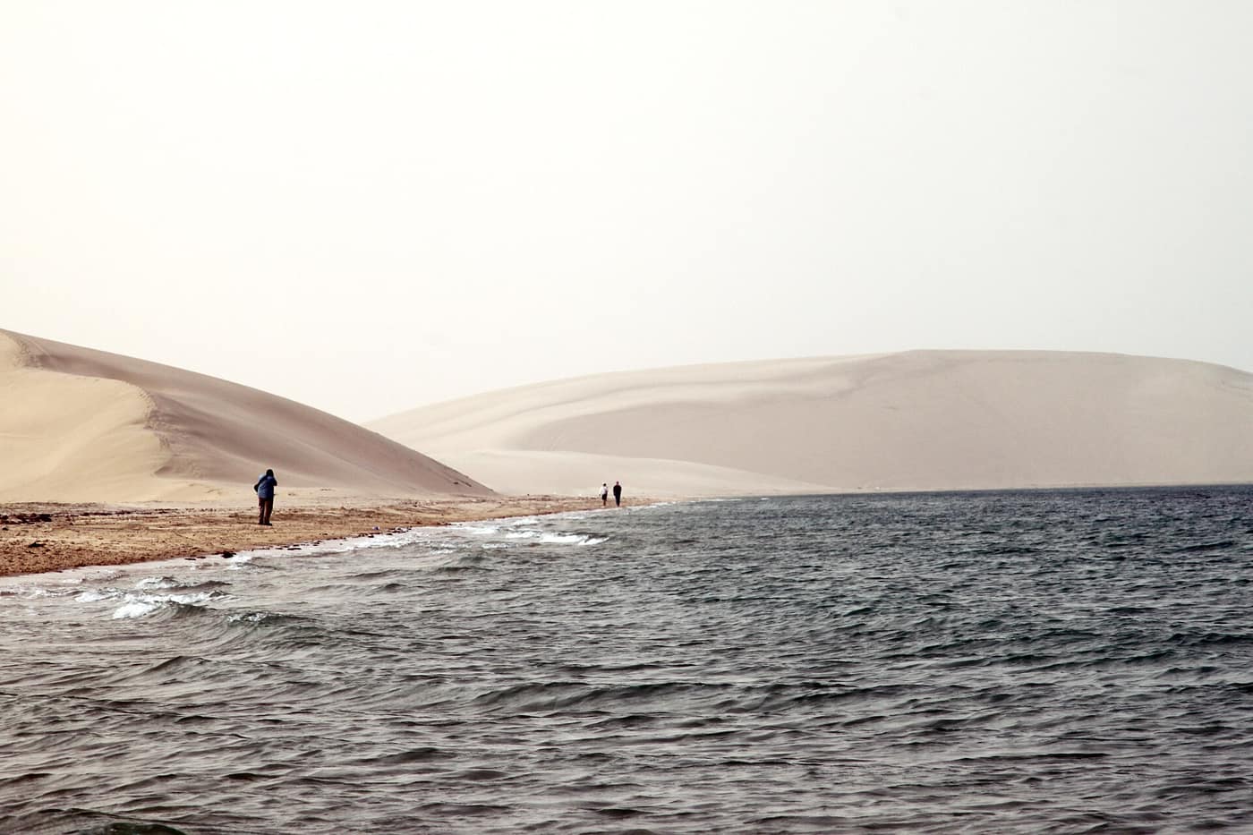 Sand dunes meeting the water at Khor Al Adaid, Qatar