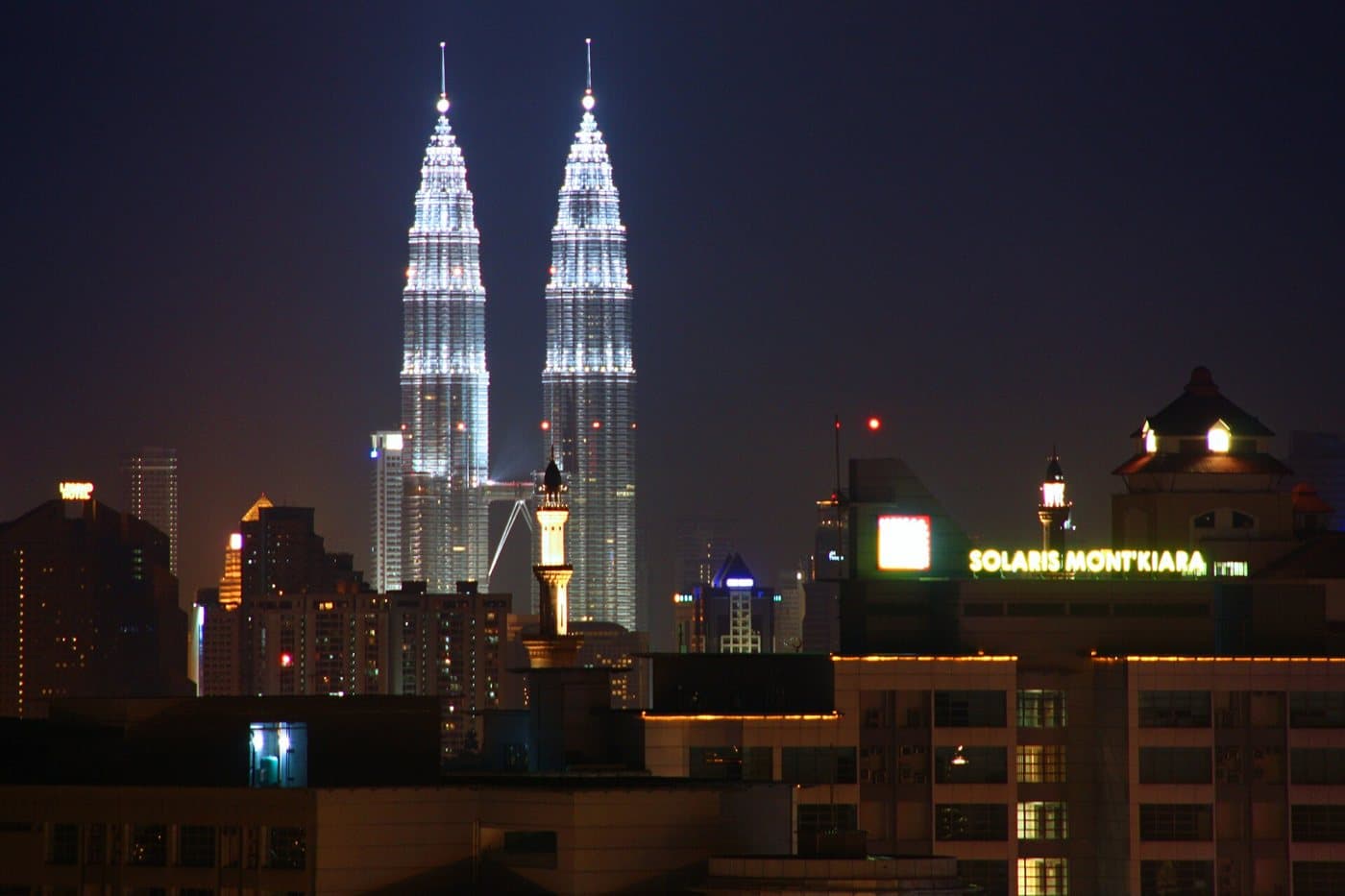 The Kuala Lumpur skyline at night, with the Petronas Twin Towers